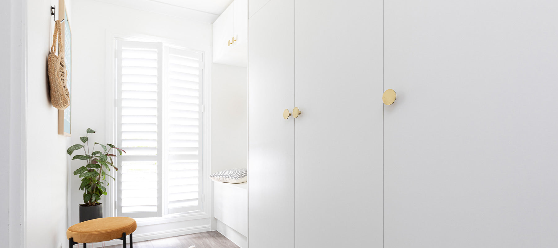 White Hallway with brass furniture knobs