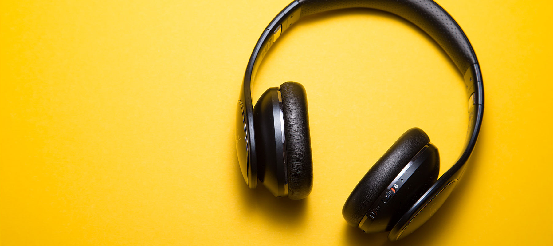 Black Headphones on yellow background